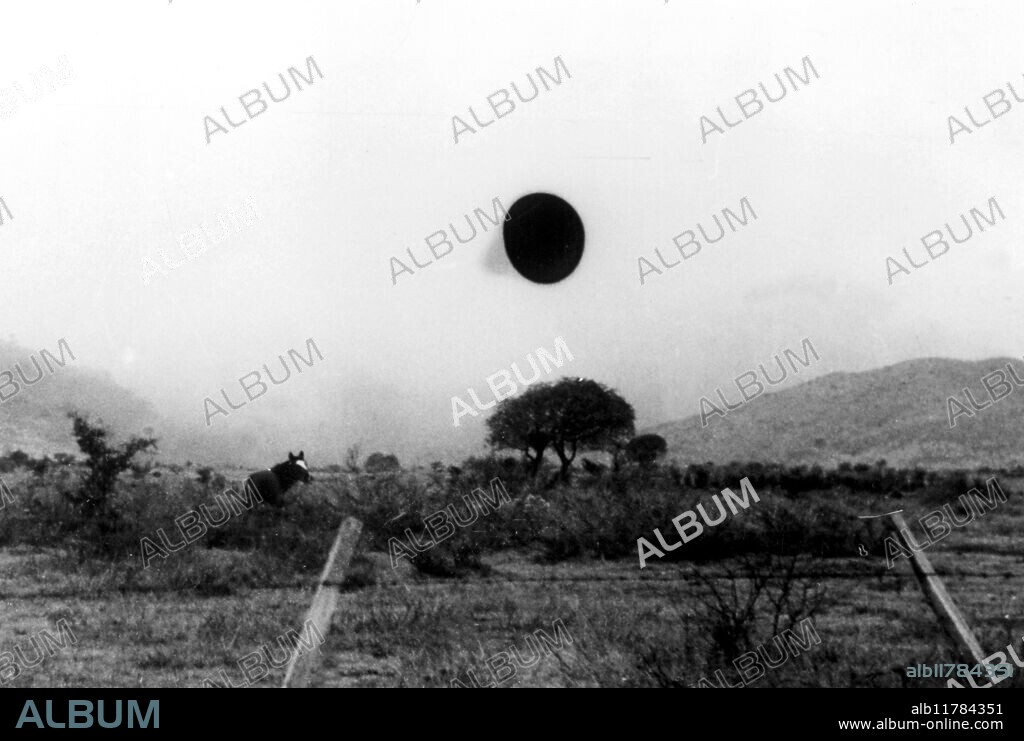 UFO photographed 3trd July 1960 between Cordoba and Yacanto, Argentina, by Captain Hugo Niotti of the Argentine Air Force (later Vice Commodore). It appeared conical and was grey and metallic; there was no sound as it rotated slowly on its axis. It then flew south and disappeared into low clouds. Computer analysis by Ground Saucer Watch found the object to be a genuine unknown. Slight enlargement from full frame - ©TopFoto / Fortean.