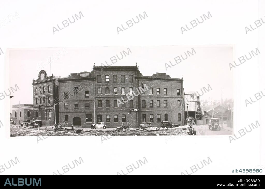 Photograph, 1886 Austral Laboratory Building & Construction Workers, Abbotsford, Victoria, 1927-1930, Black and white gelatin panoramic photograph of the Kodak Australasia factory in Abbotsford, Victoria, 1927-1930. This photograph features the multi-storey 1886 Austral Laboratory building which curves around Southhampton Crescent in Abbotsford, on the Kodak factory site. Construction is taking place over the road from the building. This building was originally part of the Austral Plate Company.