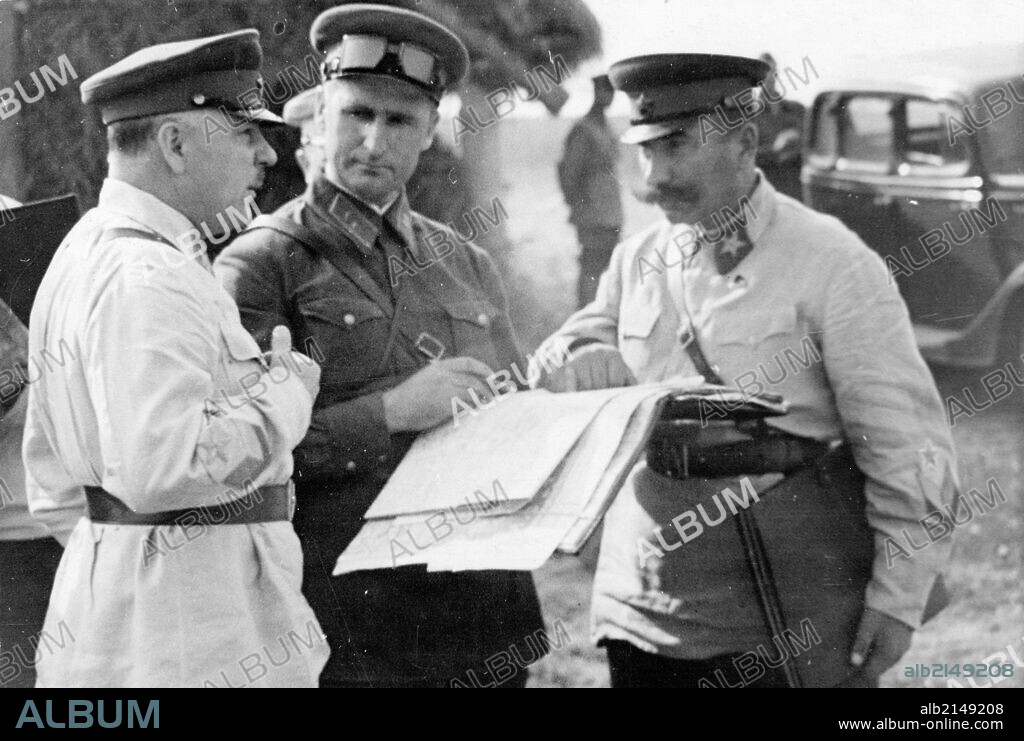 Peoples' commissar of defense, marshall kliment voroshilov, division commander vasily sokolovsky, and marshall semyon budyonny looking over a map during tactical exercises in the moscow military district, september 1938.