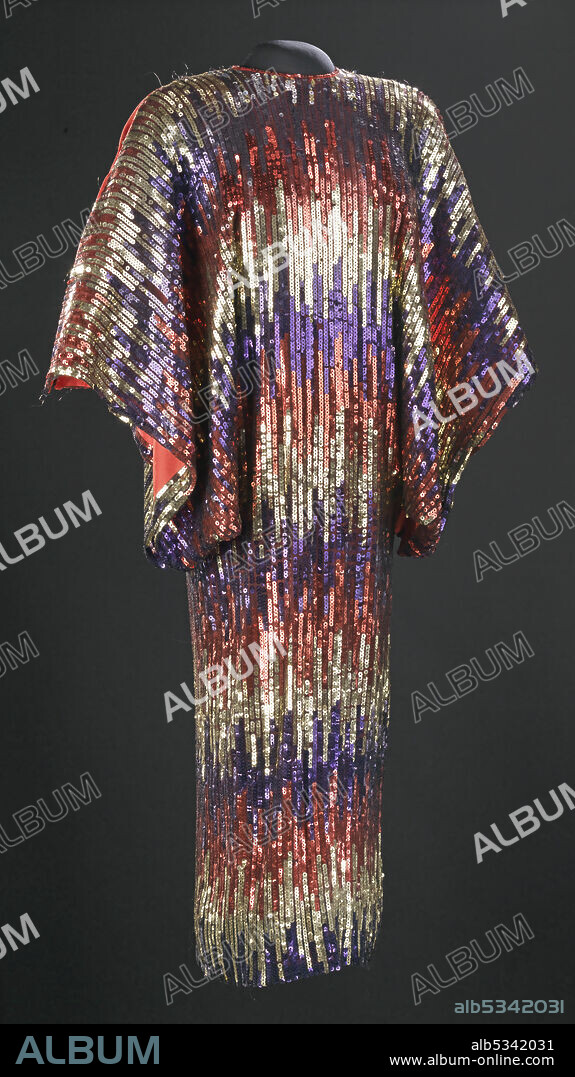 JOSé ENRIQUE ARTEAGA. Metallic floor-length dress, worn by Cuban American singer Celia Cruz (1925-2003). Red, gold, and blue sequin dress designed with horizontal, varied stripes and large open sleeves.