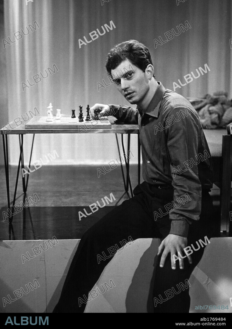 Luigi Tenco beside a chessboard. The Italian singer Luigi Tenco sitting beside a chessboard during a RAI tv show. Italy.