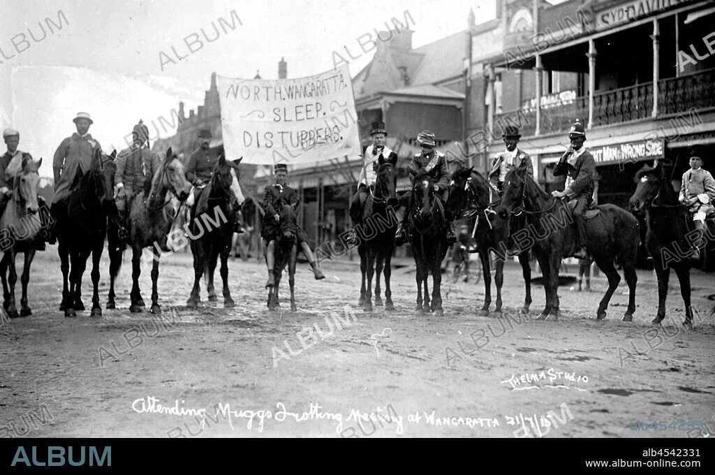 Negative - 'North Wangaratta Sleep Disturbers', Attending Muggs' Trotting Meeting, Wangaratta, Victoria, 21 Jul 1915, Boys in fancy dress on horseback at the 'Muggs Trots'. They carry a sign reading: North Wangaratta Sleep Disturbers.