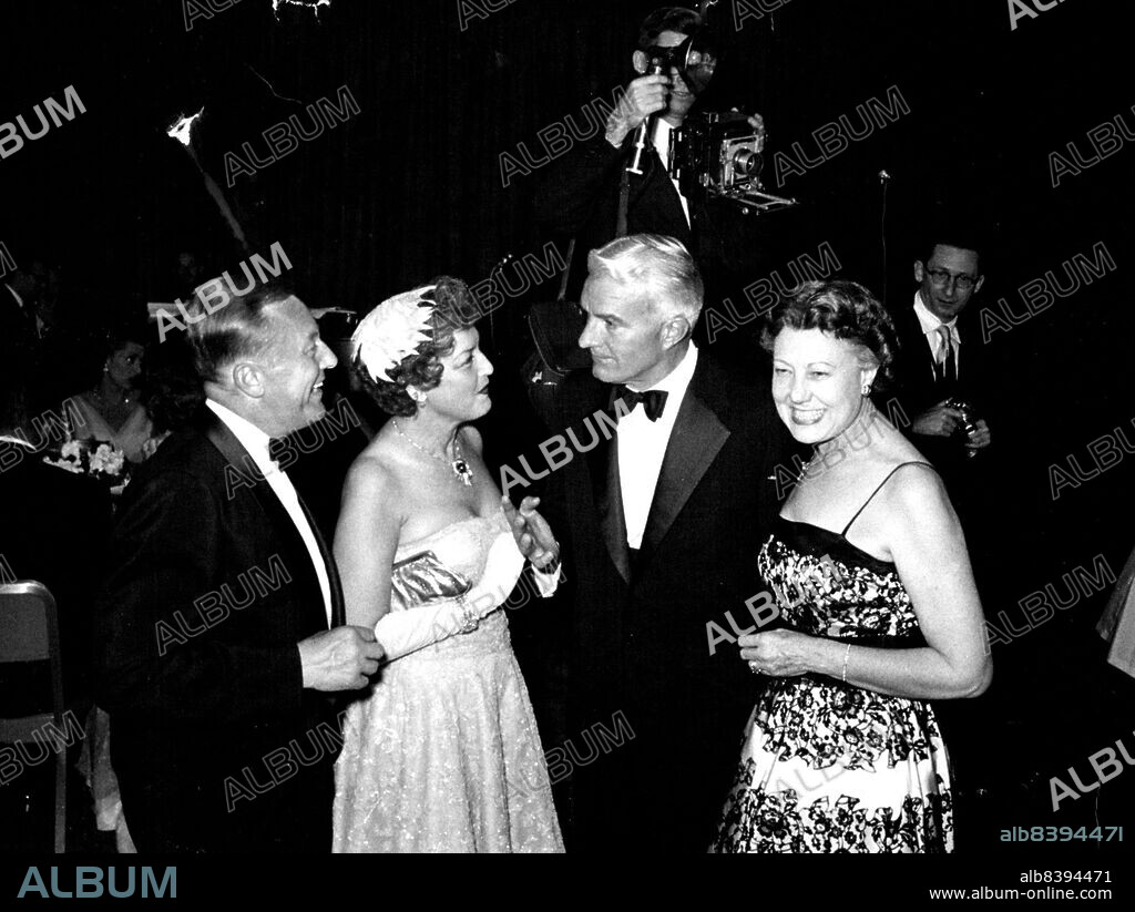 Norman Chandler receives congratulations from Gene Raymond (left) and Mrs. Raymond (singer Jeanette MacDonald) on Mrs. Chandler's campaigning. September 12, 1955. (Photo by Look Magazine).