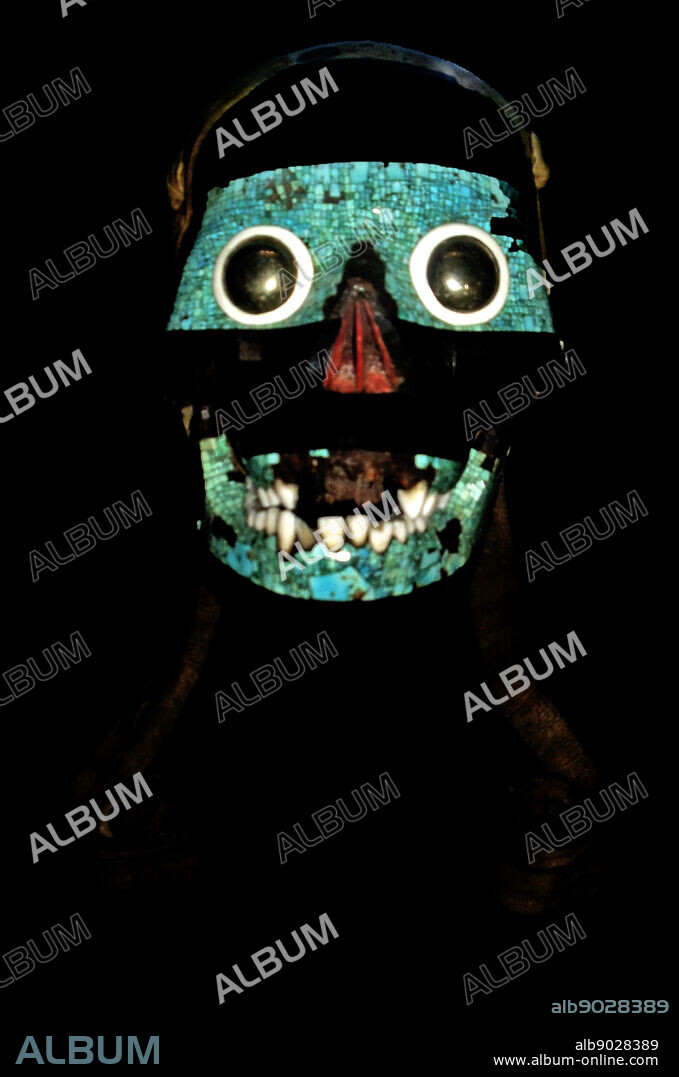 Turquoise mosaic mask of Tezcatlipoca, Mixtec-Aztec, AD 1400-1521. A human skull forms the base for this mask of Tezcatlipoca. 'Smoking Mirror', one of four powerful creator gods in the Aztec pantheon. The Aztec believed that the defeat of Quetzalcoatl by Tezcatlipoca marked the beginning of the current era of creation. The emblem of Tezcatlipoca, an obsidian mirror, symbolises his control over the hidden forces of creation and destruction. The mask is decorated with a mosaic of turquoise, lignite and shell; the eyes have been made from polished iron pyrites. The skull was probably tied around the waist by the leather straps as indicated in the Codex image.