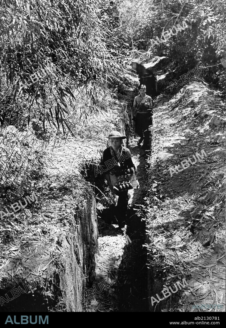 South Vietnamese villagers, Communist guerrillas, carrying grenades in a trench. Viet Cong. Vietnam War. 1966. (Photo by: Sovfoto/UIG via Getty Images).