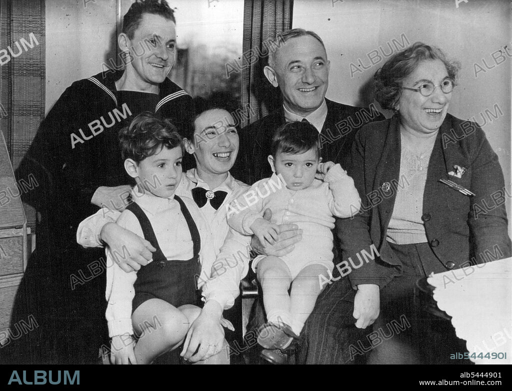 Mr.Shinwell - as the house and the country do not know him: At the home of his son-in-law, Able Seaman, Lionel Lawrence (left) and his daughter, Rose, Mr. Shinwell, in the company of his wife (right) spends a happy, homely weekend with his grandchildren, Michael and Paul. May 02, 1942.