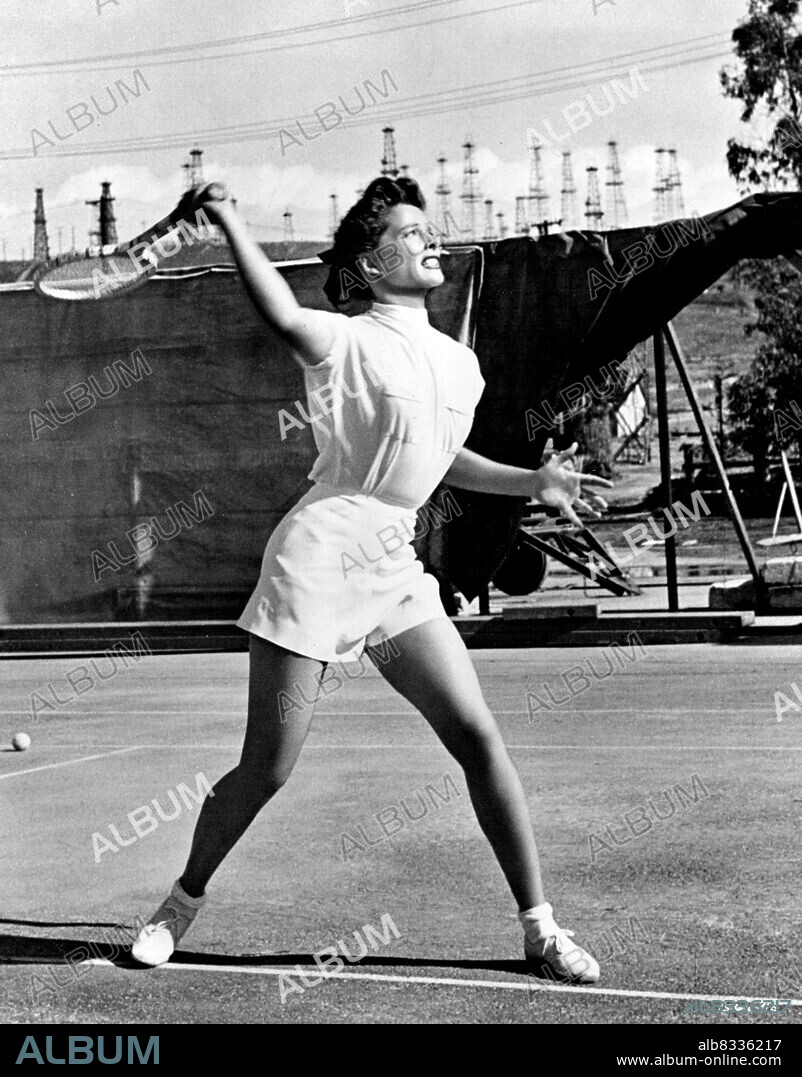 Queen Of The Court ... Katharine Hepburn is the tennis ace who plays a love of a game in M-G-M's "Pat and Mike" in which she co-stars with Spencer Tracy. As the all-round athlete, she's managed by Tracy, a tough sports manager with whom she gets embroiled romantically and professionally. Also heading the all-star cast are Aldo Ray, William Ching and such sports stars as Babe Didrikson Zaharias, Gussie Moran, Frank Parker, Don Budge, Alice Marble, Helen Dettweiler, Beverly Hanson, and Betty Hicks. Directed by George Cukor. Produced by Lawrence Weingarten. Written by Ruth Gordon and Garson Kanin. September 1, 1952.