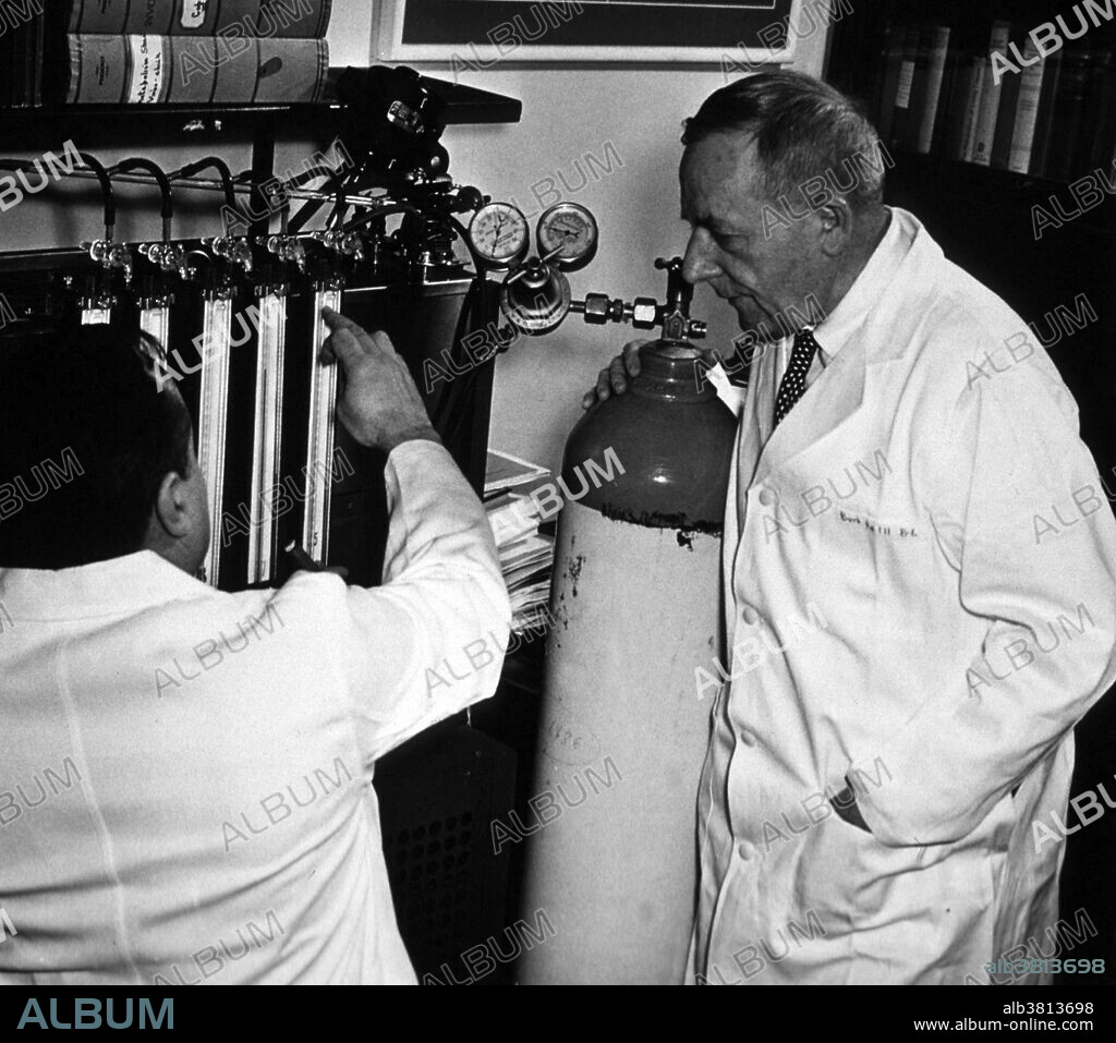 Warburg, unidentified associate, and the Warburg manometer. No date or location given. Otto Heinrich Warburg (1883-1970) was a German physician and physiologist. He served as an officer in the elite Uhlans (cavalry) on the front during the First World War where he won the Iron Cross. Towards the end of the war Albert Einstein wrote Warburg asking him to leave the army and return to academia. In 1918 Warburg was appointed Professor at the Kaiser Wilhelm Institute for Biology and later named Director of the Kaiser Wilhelm Institute for Cell Physiology. Warburg investigated the metabolism of tumors and the respiration of cells, particularly cancer cells, and in 1931 was awarded the Nobel Prize in Physiology for his "discovery of the nature and mode of action of the respiratory enzyme." In 1944, he was nominated for a second Nobel Prize in Physiology for his work on nicotinamide, the mechanism and enzymes involved in fermentation, and the discovery of flavine, but he did not win. In his later years Warburg was convinced that illness resulted from pollution and became a health advocate. He died in 1970 at the age go 86.