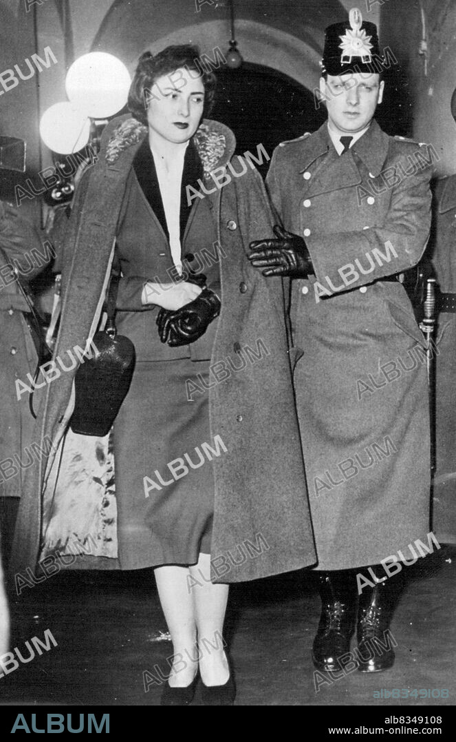 ***** Imprisonment For German Woman Spy -- Irmgard Schmidt leaving the Court under guard after being sentenced.Irmgard Schmidt, a 24 year old German girl, described as "an effective and dangerous Soviet agent with both beauty and brains", was sentenced to five years imprisonment by a U.S. High Commission Court at Bonn, on two charges of espionage.According to the prosecution Schmidt had been working for the Soviet Intelligence Service for over a year. December 24, 1954. (Photo by Sport & General Press Agency, Limited).