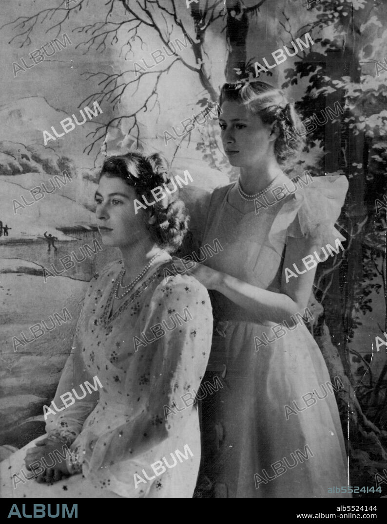 The Princess Pose -- Princess Margaret Rose (right) rests a hand on the shoulder of her sister, Princess Elizabeth, in this new study of the daughters of Kind George VI and Queen Elizabeth of Great Britain. Princess Elizabeth wears a white chiffon classical dinner dress embroidered with blue and silver stars while Princess Margaret Rose wears a youthful sheer party dress with butterfly sleeves. The Princesses are posed before a backdrop depicting a winter landscape. The picture was made by the artist-photographer Cecil Beaton. February 21, 1946. (Photo by Associated Press Photo).