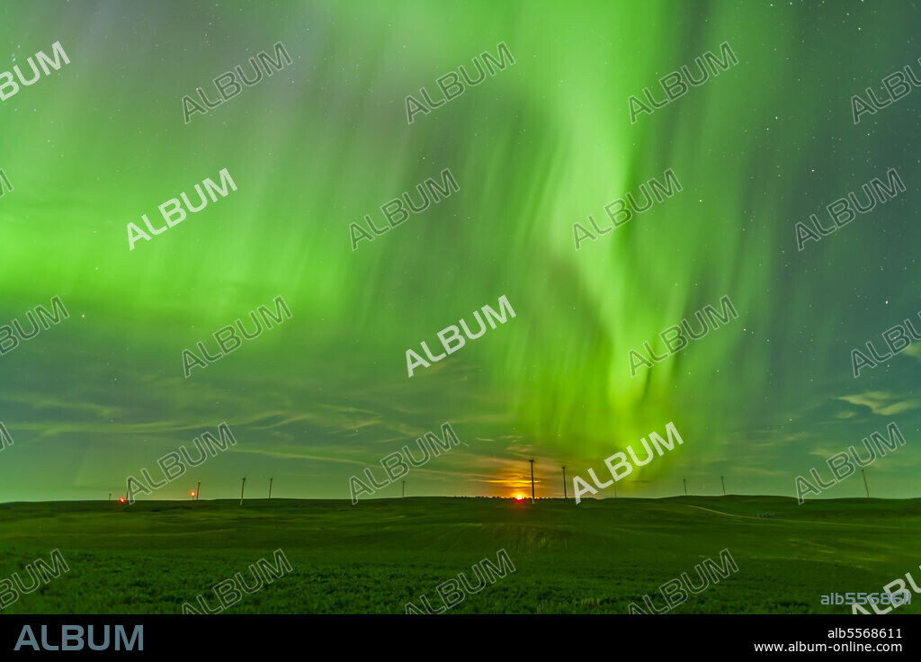 June 29, 2013 - The northern lights as seen from the Wintering Hills Wind Farm near Drumheller, Alberta, Canada. The moon is just rising as the display is reaching a peak in intensity.