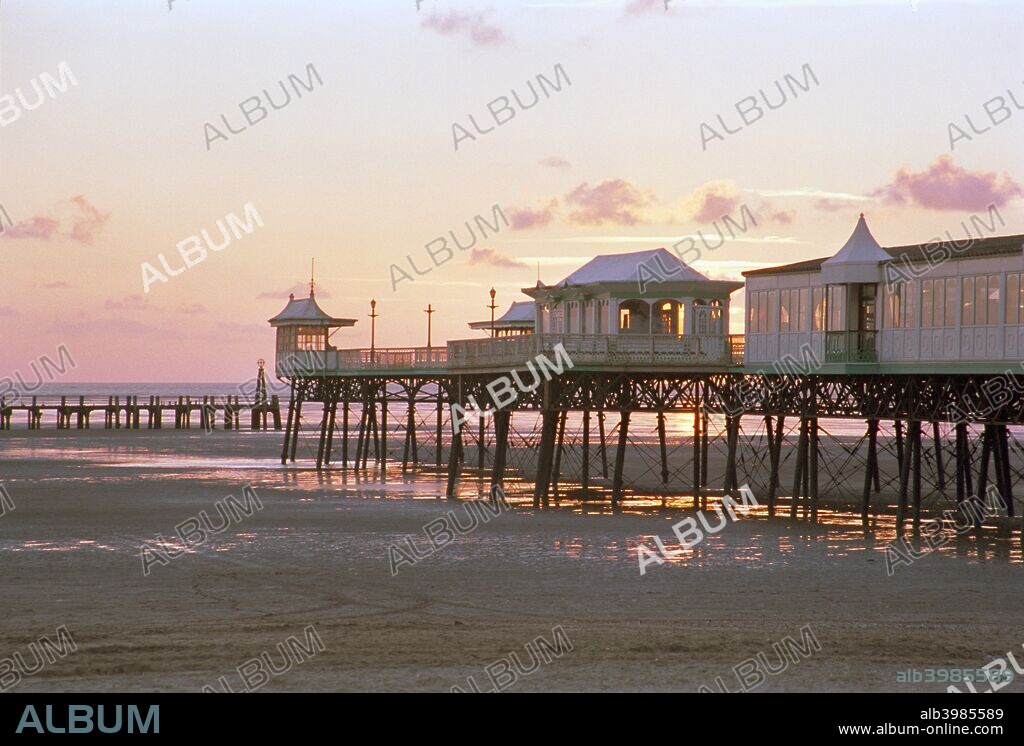 The pier at Lytham St Anne's viewed at sunset, Lancashire, 1999. It was first built in 1885 and subsequently remodelled. It is of a conventional iron column and lattice girder design. The pier pavilion was destroyed by fire in 1974.