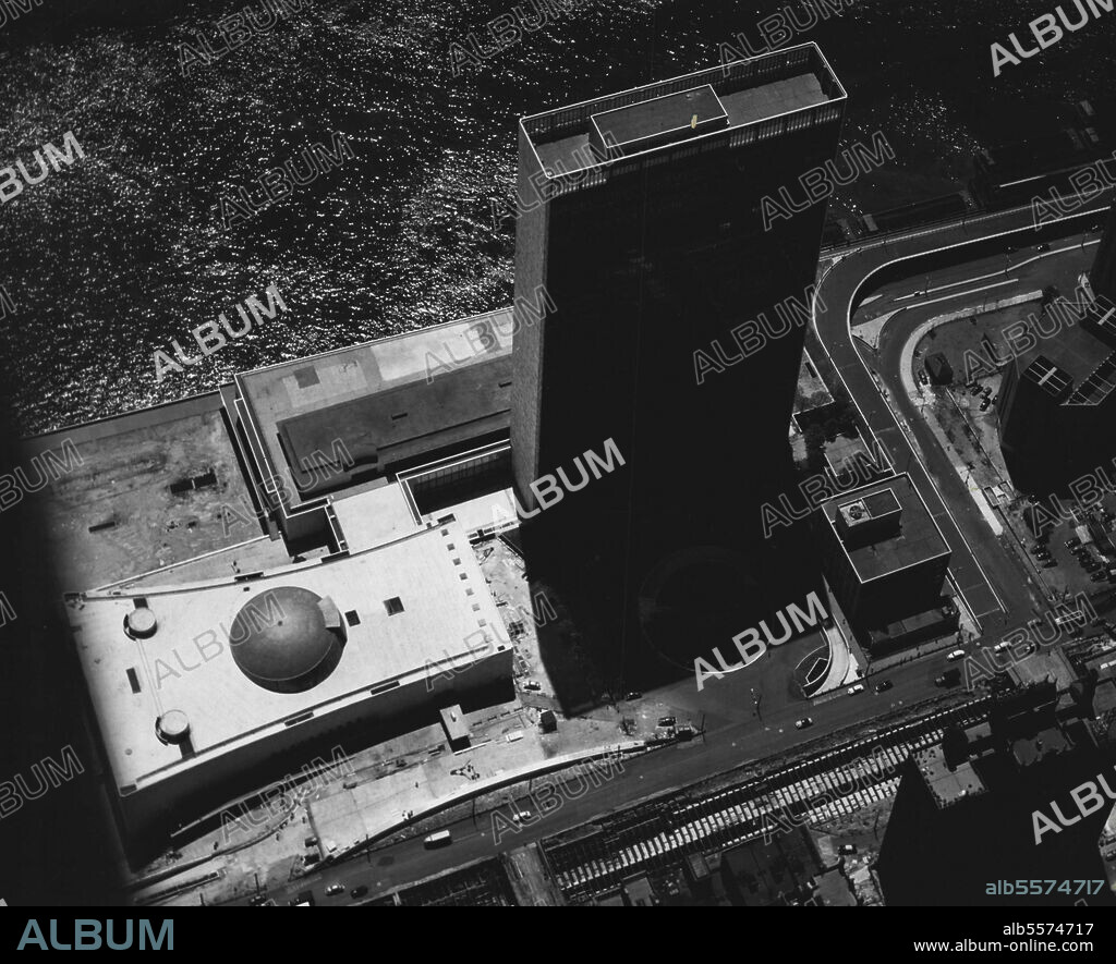 United Nations Headquarters -- Aerial view of the new permanent Headquarters of the United Nations, in New York. The four U.N. buildings are (l to r) : the General Assembly building; the Conference Areas (along the East River); the tall Secretariat building; and the Library. June 01, 1952. (Photo by U Nations).