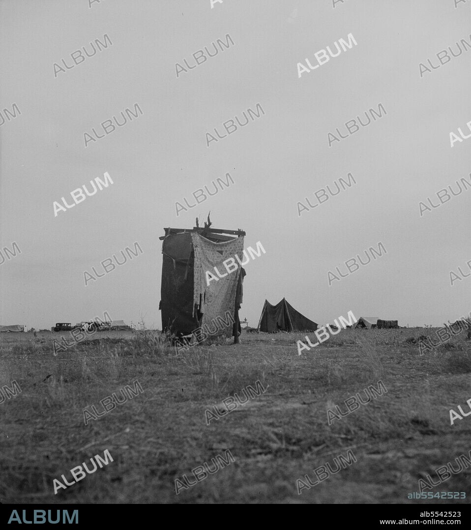 DOROTHEA LANGE. Unsanitary privy in potato pickers' camp near Shafter, California.
