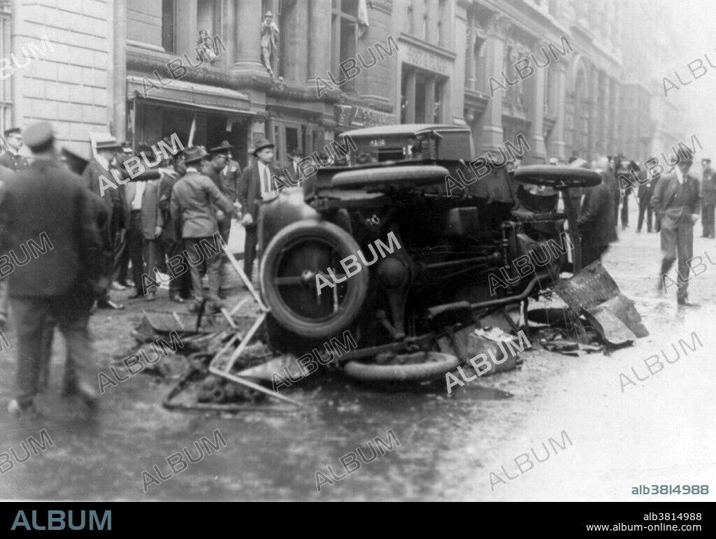 Entitled: "Anarchist bombings, New York City." On September 16, 1920, a horse drawn wagon stopped across the street from the headquarters of the J.P. Morgan bank at 23 Wall Street. Inside the wagon, 100 lbs of dynamite with 500 lbs of cast-iron sash weights exploded in a timer-set detonation. The horse and wagon were blasted into small fragments, but the driver was believed to have left the vehicle and escaped. The 38 victims, most of whom died within moments of the blast, were mostly young people who worked as messengers, stenographers, clerks, and brokers. The bomb caused more than $2 million in property damage ($23,500,000 with inflation) and destroyed most of the interior spaces of the Morgan building. There were 143 seriously injured, and the total number of injured was in the hundreds. The bombing was never solved, although investigators and historians believe the Wall Street bombing was carried out by Italian anarchists, a group responsible for a series of bombings the previous year. Photographed by Bain News Service, 1920.