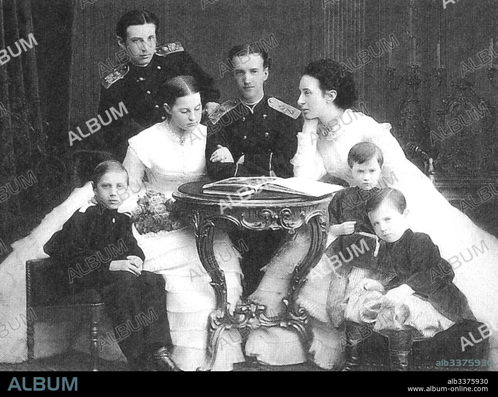 ANONYMOUS. Grand Duke Nicholas Konstantinovich (left) with sister Olga, her groom Georg of Greece, mother.