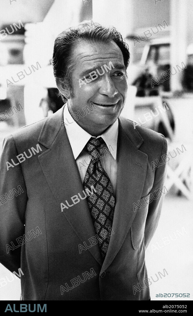 Ugo Tognazzi in jacket and tie. Portrait of a smiling Ugo Tognazzi; the actor is busy in filming Lady Caliph, that stars the Italian actor as the industrialist Annibale Doberdò. Spoleto (PG), Italy, 1970.