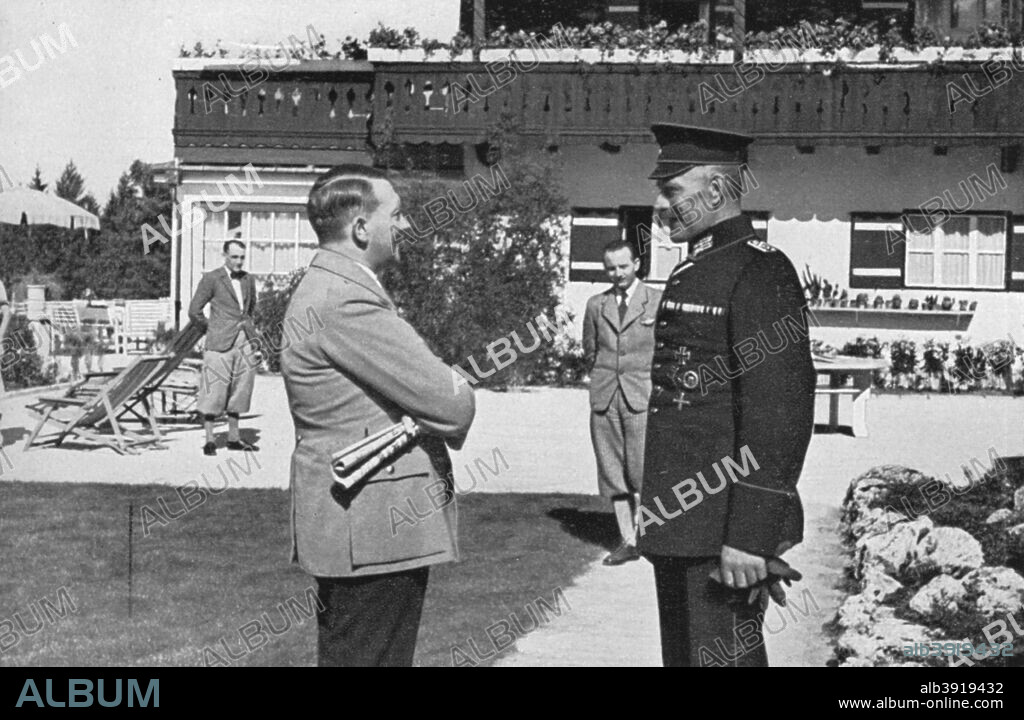 An old army comrade visits Adolf Hitler at Obersalzberg, Bavaria, Germany, 1936. Hitler (1889-1945) at his mountain retreat, the Berghof, reminiscing with a comrade from the First World War. A print from Adolf Hitler. Bilder aus dem Leben des Führers, Hamburg: Cigaretten/Bilderdienst Hamburg/Bahrenfeld, 1936.