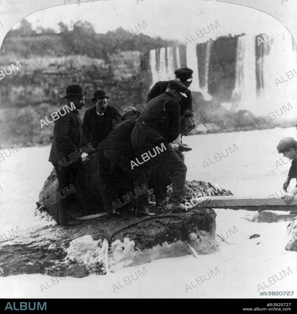 First human being to go over falls and lives. Taylor crossing Niagara River on a plank with the falls in the distance. Annie Edson Taylor (October 24, 1838 - April 29, 1921) was an American teacher. Desiring to secure her later years financially, she decided she would be the first person to ride over Niagara Falls in a barrel. Taylor used a custom-made barrel for her trip, constructed of oak and iron and padded with a mattress. On October 24, 1901, her 63rd birthday, the barrel was put over the side of a rowboat, and Taylor climbed in, along with her lucky heart-shaped pillow. After screwing down the lid, friends used a bicycle tire pump to compress the air in the barrel. The hole used for this was plugged with a cork, and she was set adrift near the American shore. The Niagara currents carried the barrel over the Canadian Horseshoe Falls. Rescuers reached her barrel shortly after the plunge. Taylor was discovered to be alive and relatively uninjured, except for a small gash on her head. She briefly earned money speaking about her experience, but was never able to build much wealth. She spent her final years posing for photographs with tourists at her souvenir stand, working as a clairvoyant, and providing magnetic therapeutic treatments to local residents. She died in 1921 at the age of 82. Cropped stereograph October 24, 1901.
