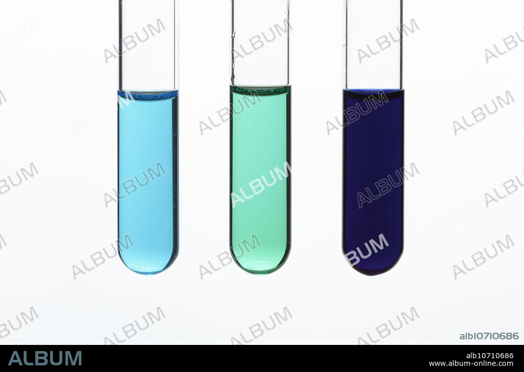 Copper ion solutions. Left: 0.5M copper sulfate water solution has a blue colour due to copper aquo complex ( (Cu(H2O)6)2+ )formation. Centre: after concentrated hydrochloric acid is added to the solution, tetrachlorocuprate complex ( (CuCl4)2- ) is formed and the solution colour changes to green. Right: after excess ammonium hydroxide is added to the original solution and tetraaminediaqua complex ( (Cu(NH3)4(H2O))2+ ) is formed and the solution colour changes to dark blue.