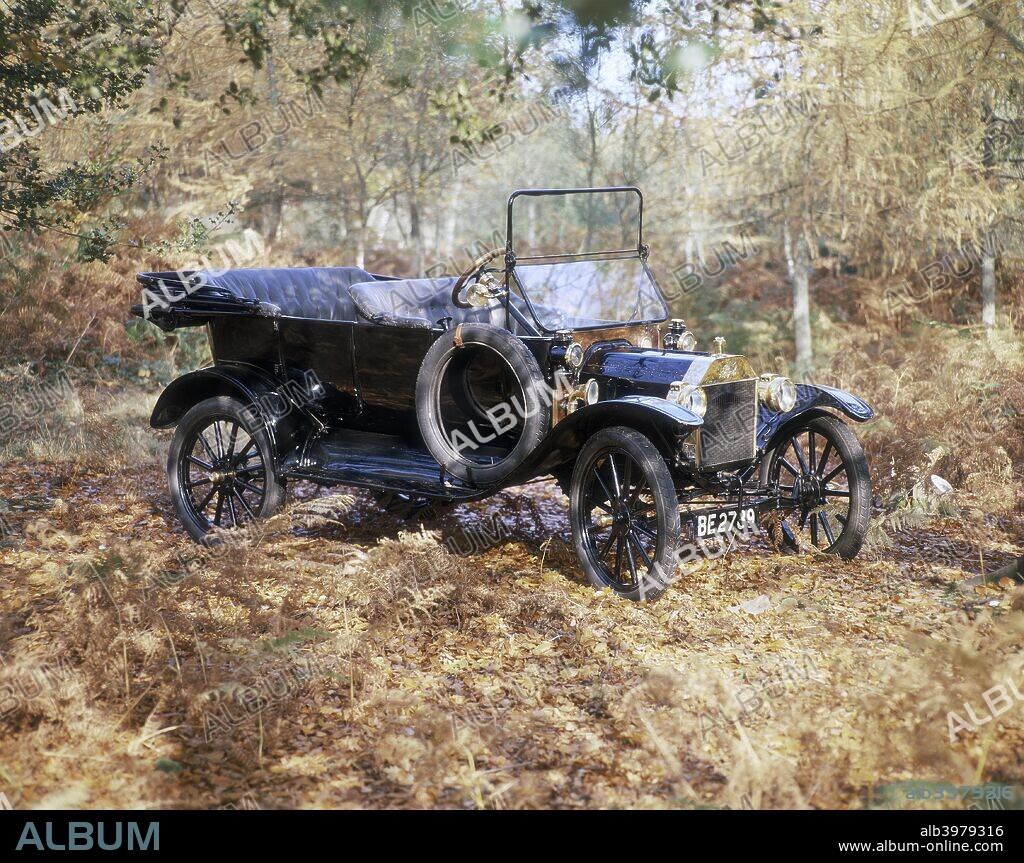 1915 Ford Model T. Classic early Ford with its hood down, in an autumnal setting. The Model T Ford car brought motoring within the range of millions of people throughout the world. Mass production on a moving assembly line and lack of frills was the reason for the low price.