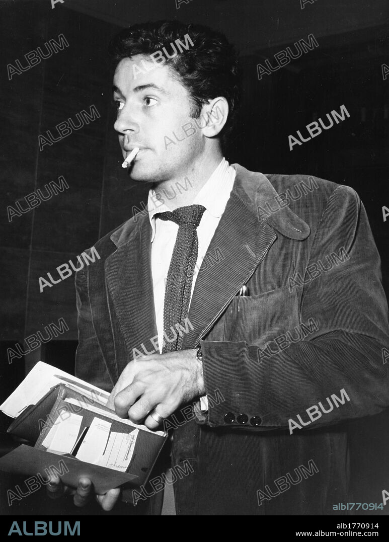 Farley Granger at the airport. The American actor Farley Granger showing his documents at the airport. Rome, 1950s.