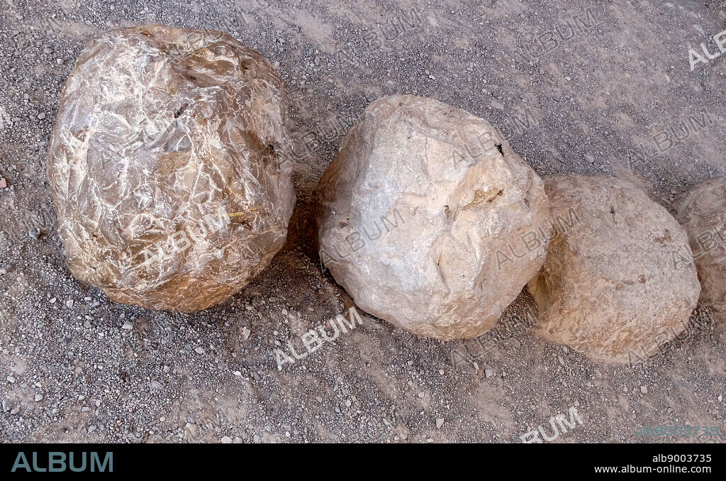 Roman artillery ballista shells fired at Masada. Masada is an ancient fortification in the Southern District of Israel situated on top of an isolated rock plateau on the edge of the Judean Desert; overlooking the Dead Sea.