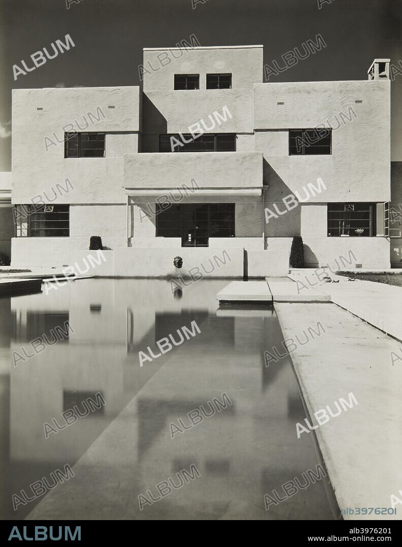 Crowsteps, Tydehams, Newbury, Berkshire, c1930. Designed by Thomas S Tait of Sir John Burnet, Tait & Lorne, and built in 1929, Crowsteps is one of the earliest Modernist houses in England. It was clearly inspired by the German architect Peter Behren's New Ways in Northampton which was built between 1925 and 1926, and Tait was commissioned on the strength of his workers' housing for Crittall's at Silver End in Essex built between 1927 and 1928. Herbert Felton, whose professional reputation owed much to his photography of Modernist architecture, has used a low point of view to take advantage of the reflective qualities of the garden pool to double the mass of the house and fill the portrait-orientated negative. Felton's ability as an architectural photographer was such that he became the first professional photographer to be employed by the National Buildings Record in 1941. Silver gelatin DOP print.