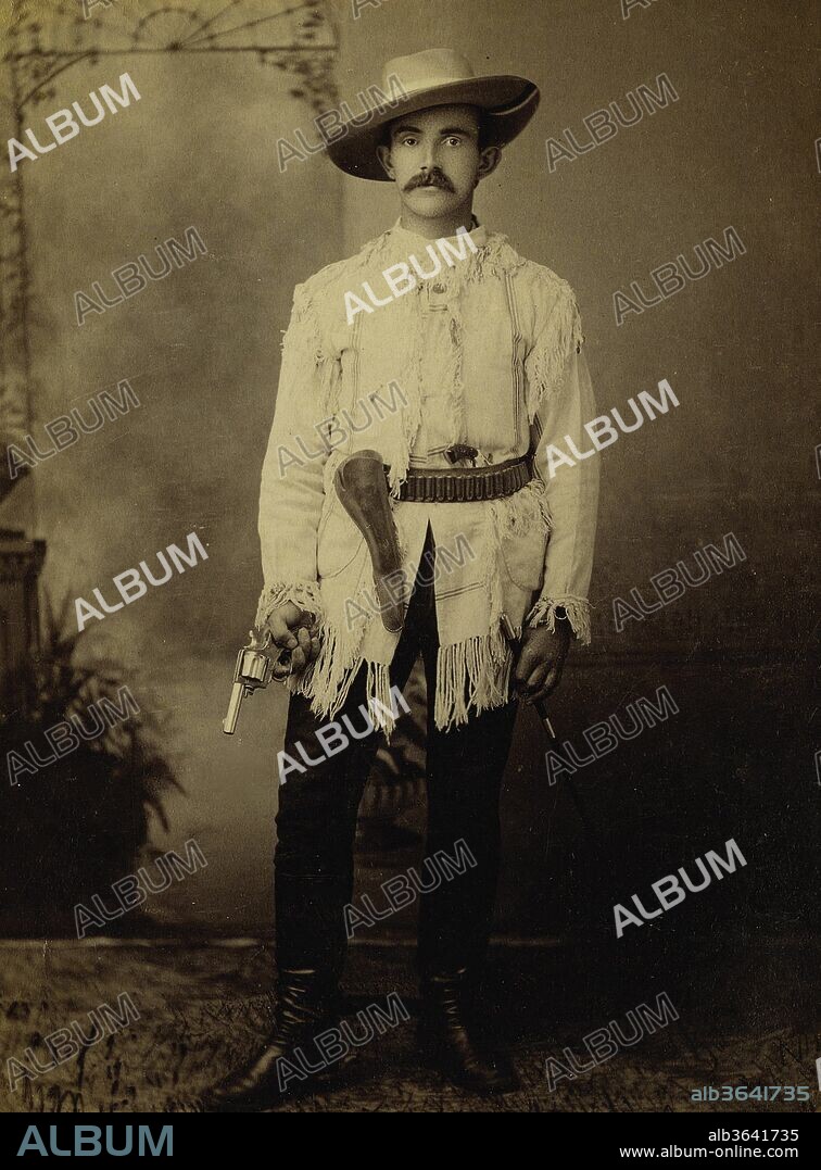 1890S Performer With Large Full Brim Cowboy Hat, Very Nice Fringed Jacket, Leather Holster, With Cartridge Belt - Has A Pistol Stuffed In His Belt, And Is Holding A Revolver In His Hand., Whiten, 1890.