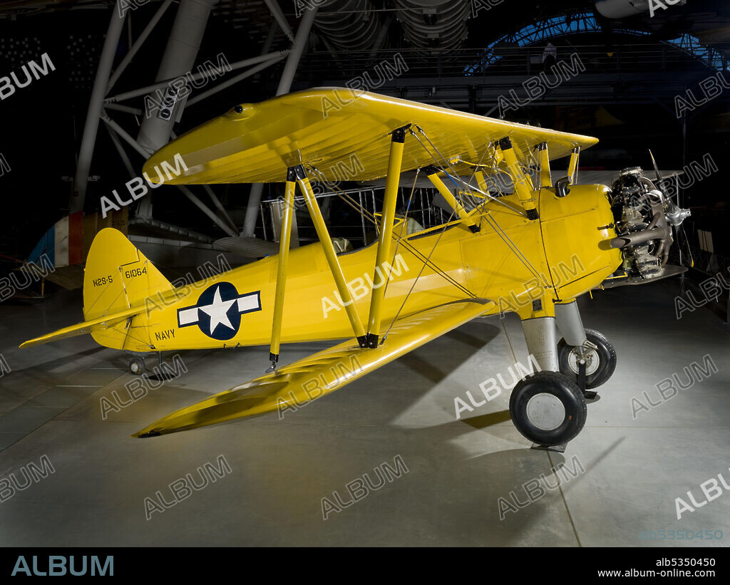 Biplane trainer, yellow. Over 10,000 Stearman trainers were built by Boeing's Wichita Division, which had purchased the Stearman Company in the late 1930s. These Kaydets, along with Fairchilds and Ryans, served as the backbone of U.S. Army and Navy primary training in World War II. The original U.S. Army Kaydet was the PT-13 with a 220 Lycoming R-680 engine. The only complete standardization of an Army and Navy production design aircraft during World War II was achieved with the Boeing-Stearman E-75, which served the Army as the PT-13D and the Navy as the N2S-5. This Kaydet was accepted by the Navy on December 7, 1943, exactly two years after the attack on Pearl Harbor. The airplane was flown to the Ottumwa, Iowa, Naval Air Station, where it was used to train naval aviation cadets until 1946.