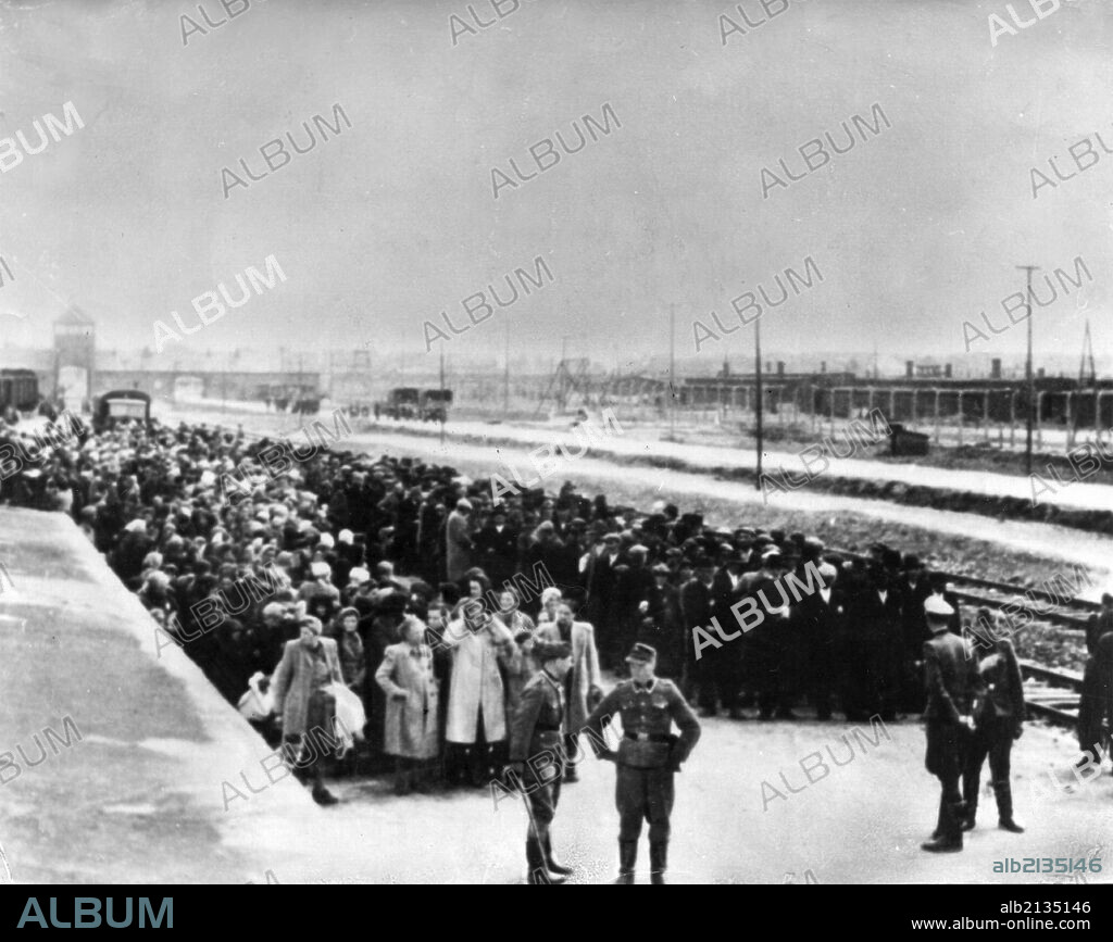Auschwitz, poland, victims of the auschwitz concentration camp stand on the platform in birkenau station, awaiting selection for either the gas chambers or forced labor, world war 2. 01/02/2013