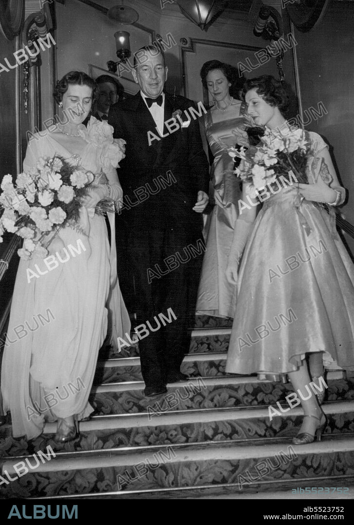 Midnight Show at London Palladium -- The Duchess of Kent in pink and carrying red carnations, Noel Coward, and Princess Alexandra in primrose with red carnations and iris arriving at the Palladium this evening for Noel Cowards midnight show "Night of 100 Stars". June 24, 1954. (Photo by Daily Mail Contract Picture).