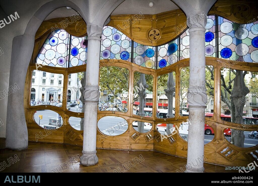Batllo House, Barcelona, Spain, 2007. Casa Battlo was built in 1877 and remodelled by Antonio Gaudi in the years 1905-1907 for the Battlo family, living in the first floor. Because of the curved roof and skeletal organic quality, the local name for the building is House of Bones or House of the Dragon. A common theory is that the house represents the battle of Saint George with the dragon. The building is decorated in Modernisme style, with a mosaic made of broken ceramic tiles in shades of orange, green and blue. Along with Casa Ametllar and Casa Lleo-Morera, it makes up the three most important buildings in Barcelona's famous 'Illa de la Discordia' (Block of Discord') [formerly known as 'Apple of Discord' (manzana de la Discordia)], noted for its unique modernist buildings. The building was awarded as one of the three best buildings of the year 1906 by the Barcelona City Council; Battlo House is one of the seven works of Gaudi that were declared World Heritage sites by UNESCO in 1984.