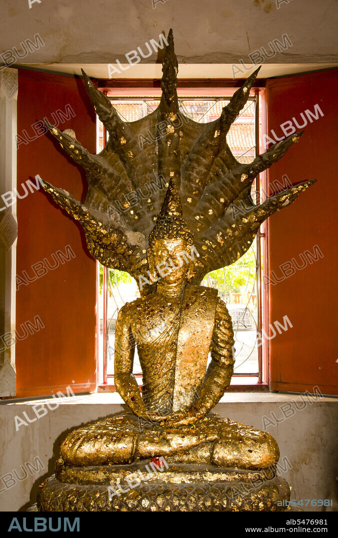 The Buddhist temple of Wat Phra Thong, the Temple of the Golden Buddha can be found in the Thalang District of Phuket Island. This unusual temple is named for the golden (or gilded) Buddha image that is buried within the temple precincts so that only the head and shoulders are visible above ground. According to legend, a local buffalo boy attempted to tether one of his charges to an outcrop he thought was a tree stump, but which proved to be the ushnisha or top-knot of a buried Buddha image. For this albeit unintentional heresy, both the boy and the buffalo died. It was later revealed to the boys father in a dream that his son had in fact been transported to nirvana rather than being punished, and when the local lord heard this story he ordered the image dug up and suitably installed in a temple. However, despite the Thalang villagers best efforts, the image could not be fully excavated, and remained buried from the shoulders down. Consequently a roof was erected to shelter the exposed head and shoulders, making the image and surrounding temple a place of great veneration for both local Thais and Chinese migrants. Today the temple is among the most venerated of Buddhist sites not just in Phuket, but in all southern Thailand.