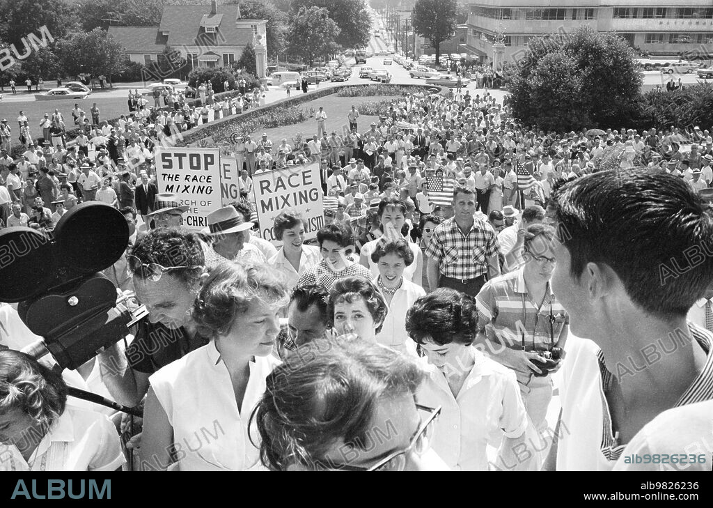 Crowd at Arkansas State Capitol protesting integration of Central High School, with signs reading ""Race mixing is Communism"" and ""Stop the race mixing,"" Little Rock, Arkansas, USA, John T. Bledsoe, U.S. News & World Report Magazine Photograph Collection, August 20, 1959.