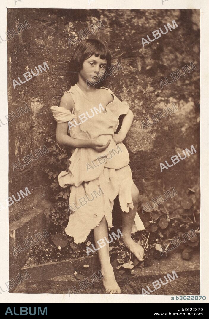 LEWIS CARROLL (ECRIVAIN). Alice Liddell as "The Beggar Maid". Artist: Lewis Carroll (British, Daresbury, Cheshire 1832-1898 Guildford). Dimensions: Image: 16.3 x 10.9cm (6 7/16 x 4 5/16in.)
Mount: 14 1/8 in. × 10 7/8 in. (35.8 × 27.6 cm). Subject: Alice Pleasance Liddell (British, 1852-1934). Date: 1858.
Known primarily as the author of children's books, Lewis Carroll was also a lecturer in mathematics at Oxford University and an ordained deacon. He took his first photograph in 1856 and pursued photography obsessively for the next twenty-five years, exhibiting and selling his prints. He stopped taking pictures abruptly in 1880, leaving over three thousand negatives, for the most part portraits of friends, family, clergy, artists, and celebrities. Ill at ease among adults, Carroll preferred the company of children, especially young girls. He had the uncanny ability to inhabit the universe of children as a friendly accomplice, allowing for an extraordinarily trusting rapport with his young sitters and enabling him to charm them into immobility for as long as forty seconds, the minimum time he deemed necessary for a successful exposure. The intensity of the sitters' gazes brings to Carroll's photographs a sense of the inner life of children and the seriousness with which they view the world.
Carroll's famous literary works, "Alice's Adventures in Wonderland" (1865) and "Through the Looking Glass and What Alice Found There" (1872), were both written for Alice Liddell, the daughter of the dean of Christ Church, Oxford. For Carroll, Alice was more than a favorite model; she was his "ideal child-friend," and a photograph of her, aged seven, adorned the last page of the manuscript he gave her of "Alice's Adventures Underground." The present image of Alice was most likely inspired by "The Beggar Maid," a poem written by Carroll's favorite living poet, Alfred, Lord Tennyson, in 1842. If Carroll's images define childhood as a fragile state of innocent grace threatened by the experience of growing up and the demands of adults, they also reveal to the contemporary viewer the photographer's erotic imagination. In this provocative portrait of Alice at age seven or eight, posed as a beggar against a neglected garden wall, Carroll arranged the tattered dress to the limits of the permissible, showing as much as possible of her bare chest and limbs, and elicited from her a self-confident, even challenging stance. This outcast beggar will arouse in the passer-by as much lust as pity. Indeed, Alice looks at us with faint suspicion, as if aware that she is being used as an actor in an incomprehensible play. A few years later, a grown-up Alice would pose, with womanly assurance, for Julia Margaret Cameron.