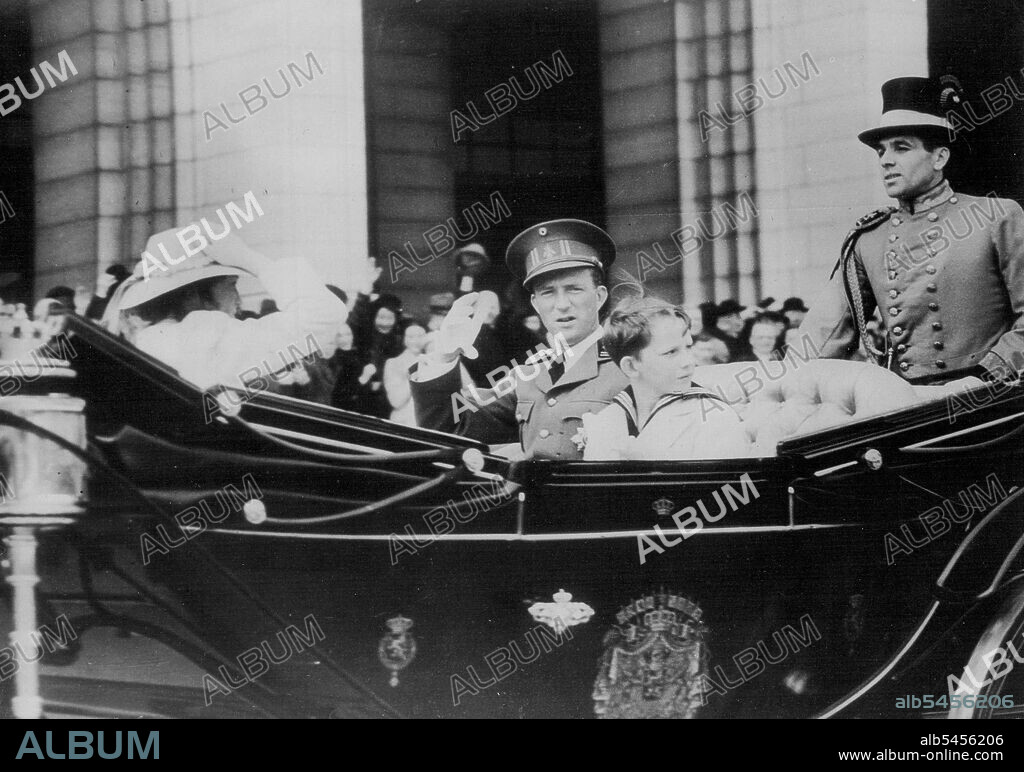 King Leopold And His Children Drive To Horse Show. King Leopold of the Belgians and his two children, Prince Baudouin and Princess Josephine Charlotte, as they drove in an open carriage to the Palais du Centenaire, Brussels to attend the Horse Show. May 14, 1939.