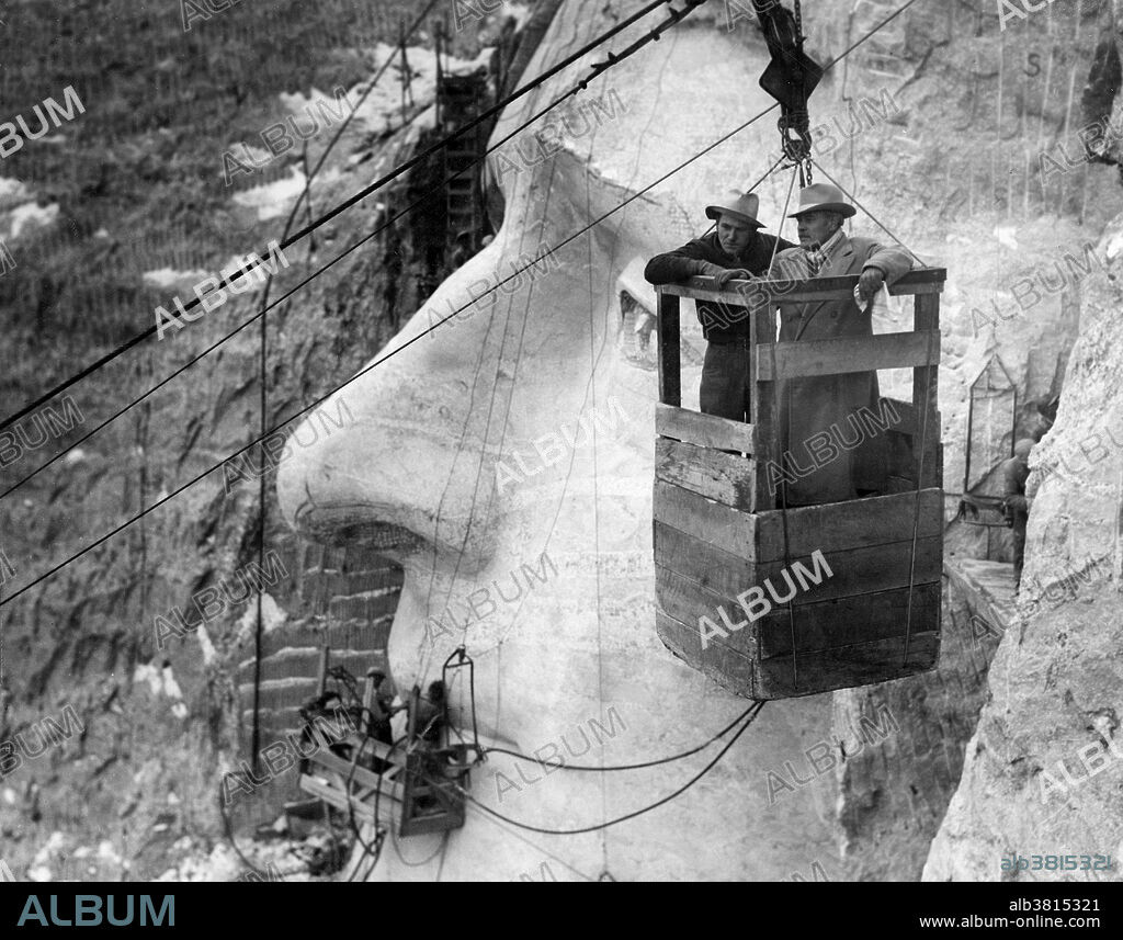 Mount Rushmore National Memorial is a sculpture carved into the granite face of Mount Rushmore near Keystone, South Dakota. Sculpted by Danish-American Gutzon Borglum and his son, Lincoln Borglum, Mount Rushmore features 60 foot sculptures of the heads of four United States presidents: George Washington, Thomas Jefferson, Theodore Roosevelt, and Abraham Lincoln. Construction on the memorial began in 1927, and the presidents' faces were completed between 1934 and 1939. Although the initial concept called for each president to be depicted from head to waist, lack of funding forced construction to end in late October 1941. Mount Rushmore has become an iconic symbol of the United States, and attracts over three million visitors annually. Photographed by Charles D'Emery, undated.