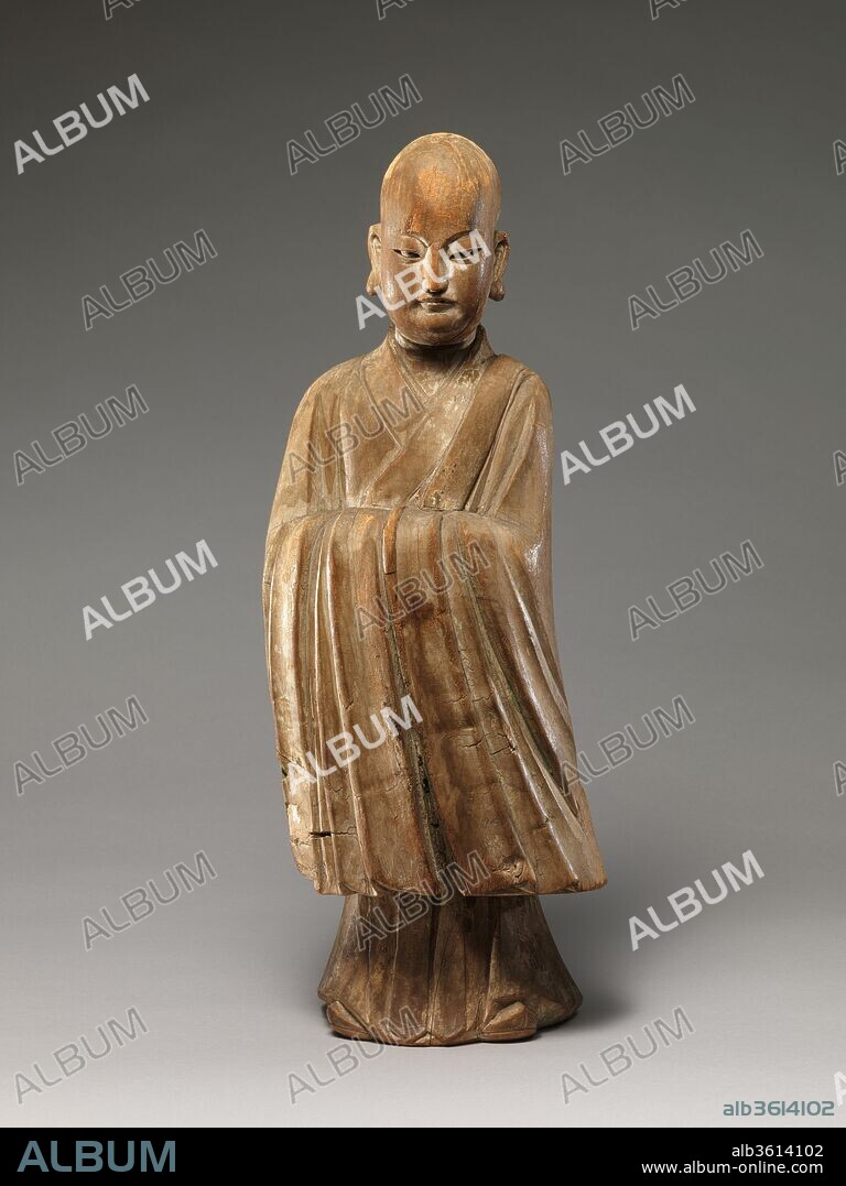 Arhat (Luohan). Culture: China. Dimensions: H. 19 1/8 in. (48.6 cm); W. 7 in. (17.8 cm). Date: 16th-17th century.
This sculpture epitomizes the merging of religious and secular imagery in later Chinese Buddhist sculpture. With his shaven head and elongated earlobes, the figure resembles a luohan (one of the Indian disciples of the Buddha), but his refined facial features, dignified posture, long-sleeved robe, and pointed shoes--all attributes associated with Confucian scholar-officials--identify him unmistakably as a youthful monk.
The sculpture's tendency toward abstraction and stylization--the contours of the head, body, and robes are conveyed through the buildup of simple, curved forms--recall thirteenth-century images, but a radiocarbon date suggests that the piece dates to between A.D. 1324 and 1617.