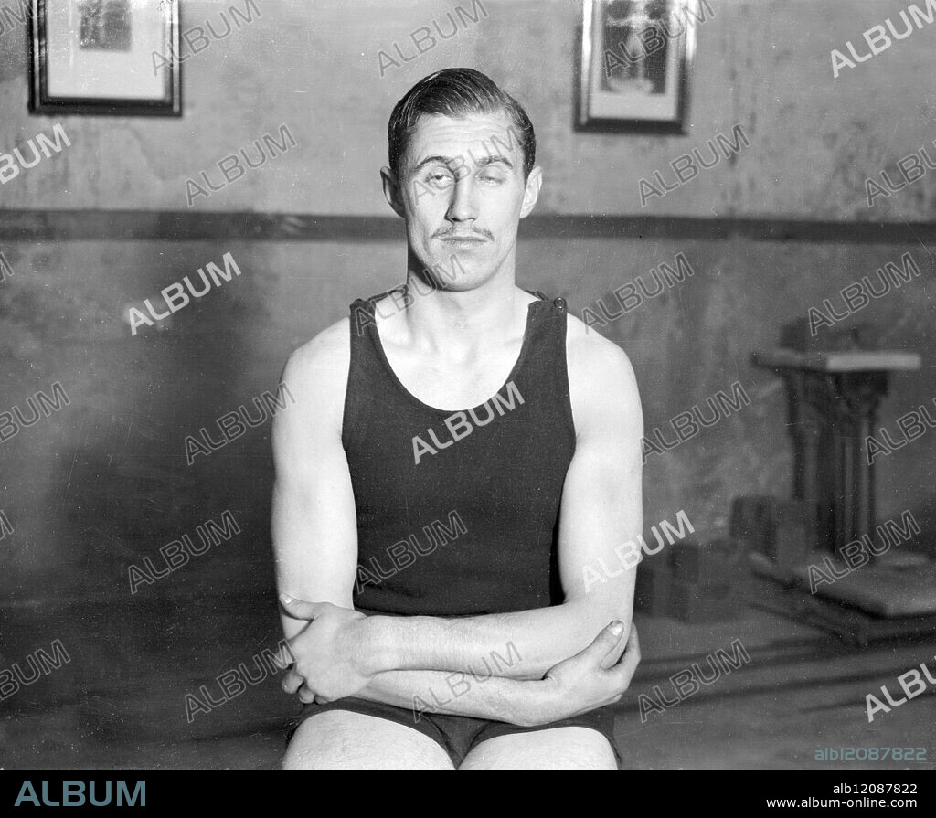 BOXING PEER IN TRAINING FOR FIGHT WITH POLICE-CONSTABLE. : Lord Knebworth, the 23 year old heir of the Earl of Lytton, who has already distinguished himself as a boxer of the welter-weight class, is in strict training for his four-round contest with Police Constable Bone of the Metropolitan Police at Ilford on April 2. He is training under Mr Alan Lambert with Alf Mancini, the professional boxer, as his sparring partner. Photo Shows: Lord Knebworth at his training quarters. United Kingdom 1928.