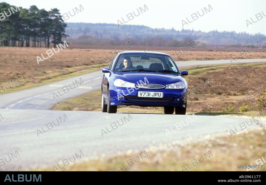 1999 Ford Mondeo ST 200 driving along country road.