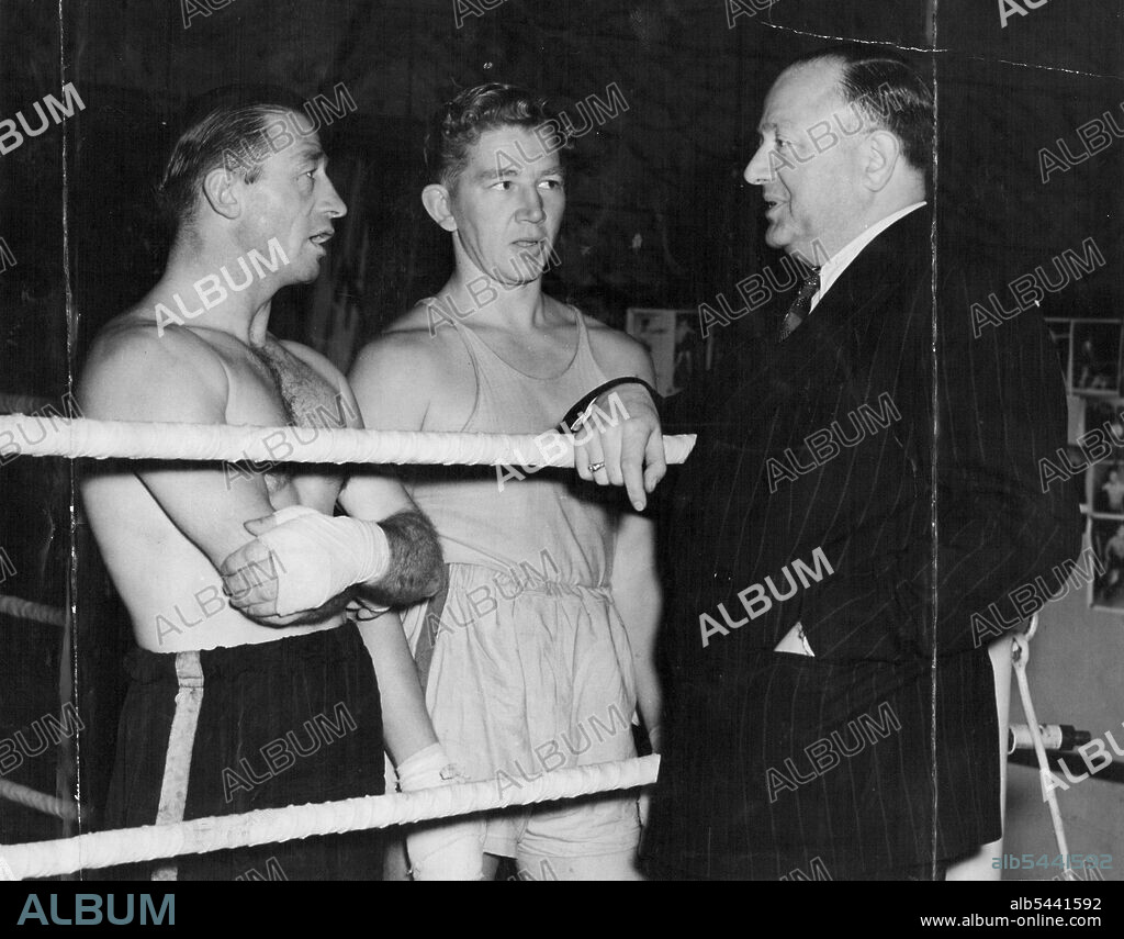 Australian Boxer Brothers-in-Law in England For Series of Fights. Jack Solomons talking to Eddie Miller (left) and Terry O'Toole (centre) at his gymnasium. Two Australian Boxers, who are brothers-in-law are in London, at present training at Jack Solomons gymnasium for a series of fight engagements. They are Terry O'Toole a prominent lightweight, and Eddie Miller, feather-weight champion of Australia. May 1, 1947. (Photo by Topical Press).