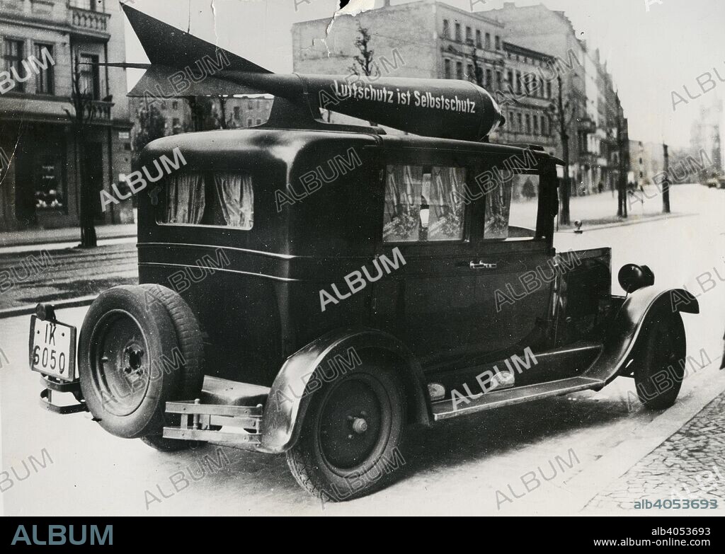 Aircraft bomb in the streets of Wroclaw, Poland, 1944. In the streets of Breslau the most effective advertising for the promotion of German air safety is made by cars driving through the city with dummy aerial bombs lying on their roofs.