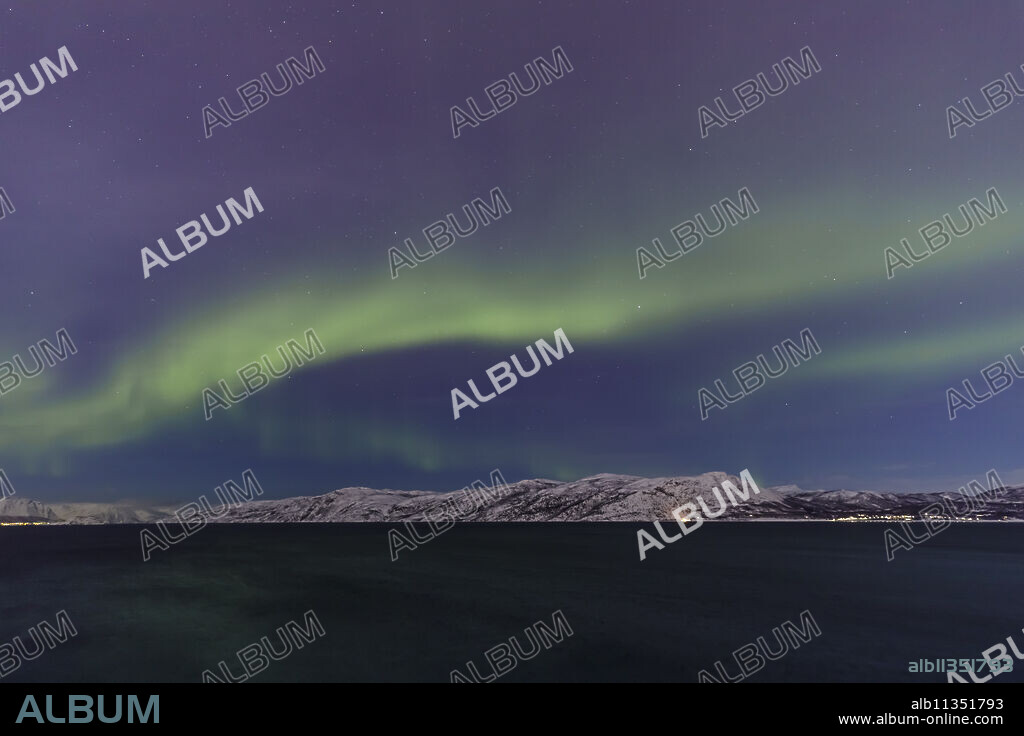 Northern Lights (Aurora Borealis) over mountains of Altafjord in winter, Alta, Troms og Finnmark, Arctic Circle, North Norway, Scandinavia, Europe.