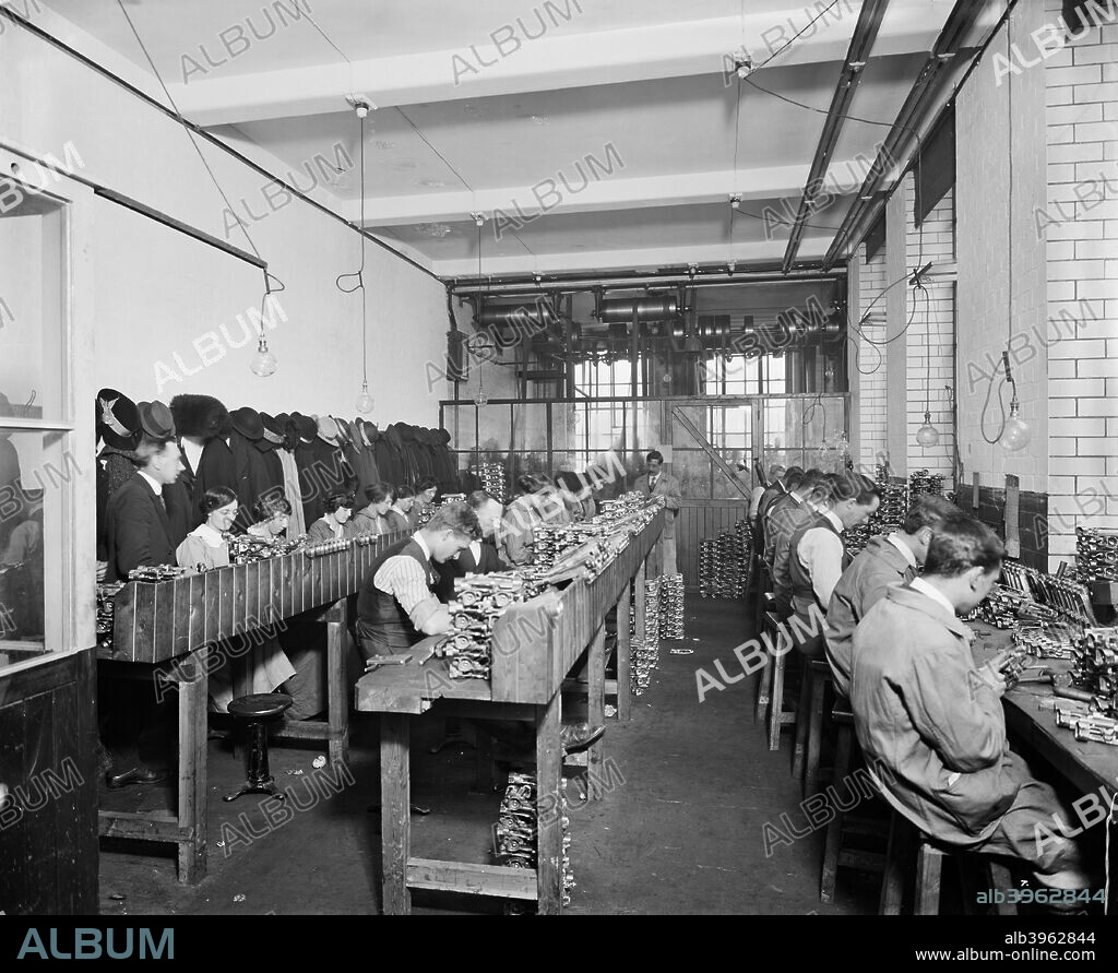 The Birmingham Small Arms factory, Small Heath, Birmingham, February 1917. Rows of men and women at work in the examination branch room during the First World War. One of series of photographs of the BSA factory which produced rifles, Lewis guns, shells and military vehicles.