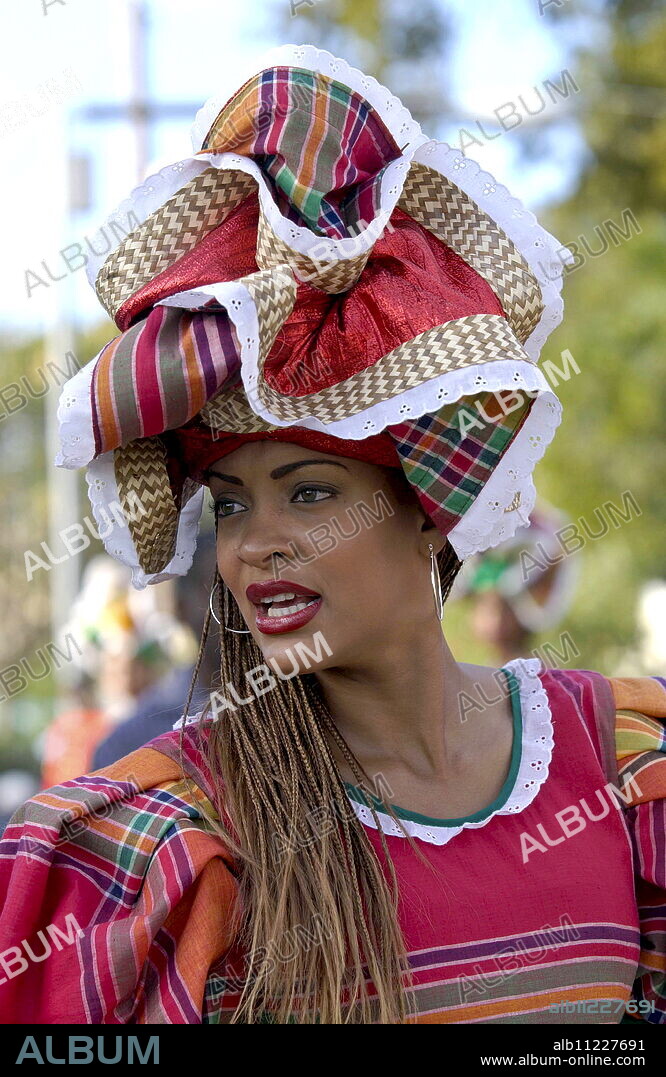 Woman in Jamaican National costume at cultural festival in Kingston, Jamaica, Caribbean.