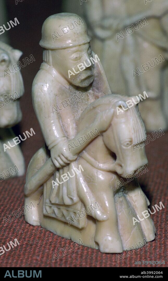The Lewis Chessmen, (Norwegian?), c1150-c1200. A Knight piece from a collection of ninety-three found at Uig on the Isle of Lewis, Outer Hebrides, Scotland. Taking the form of seated kings and queens, mitred bishops, knights on their mounts, standing warders and pawns in the shape of obelisks, most of them are made from Walrus ivory, and a few from whale teeth. From the British Museum's collection.