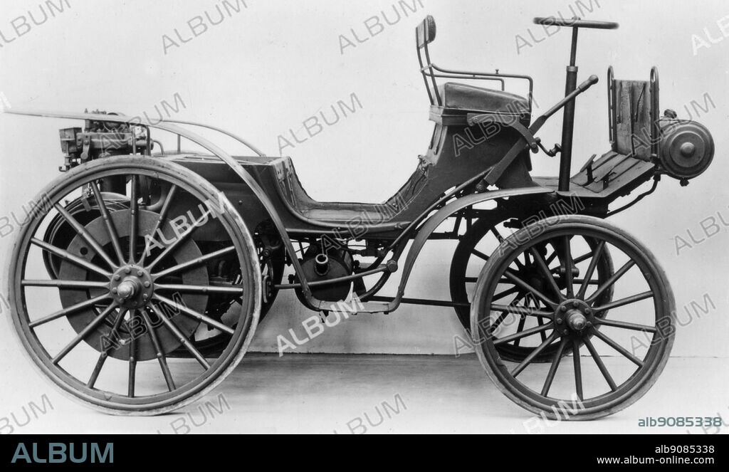 Cannstadt Daimler Motor Car 1895. An example of the first type of car made at Daimlers own works at Cannstadt. A verticle two cylinder engine is suspended at the rear. This drives by means of belts, a countershaft which is geared to internally toothed rings fixed to the wheels.
