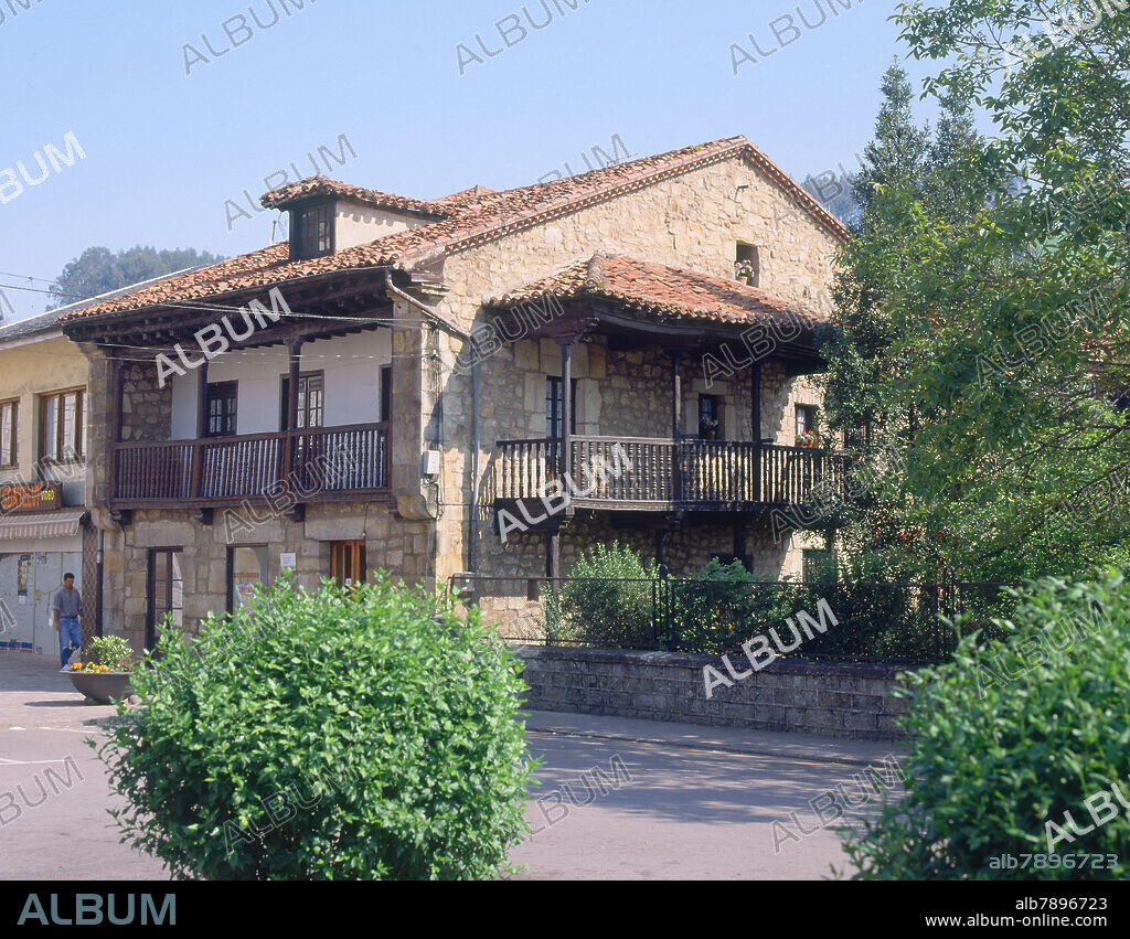 CASA DE PIEDRA CON BALCONES DE MADERA.