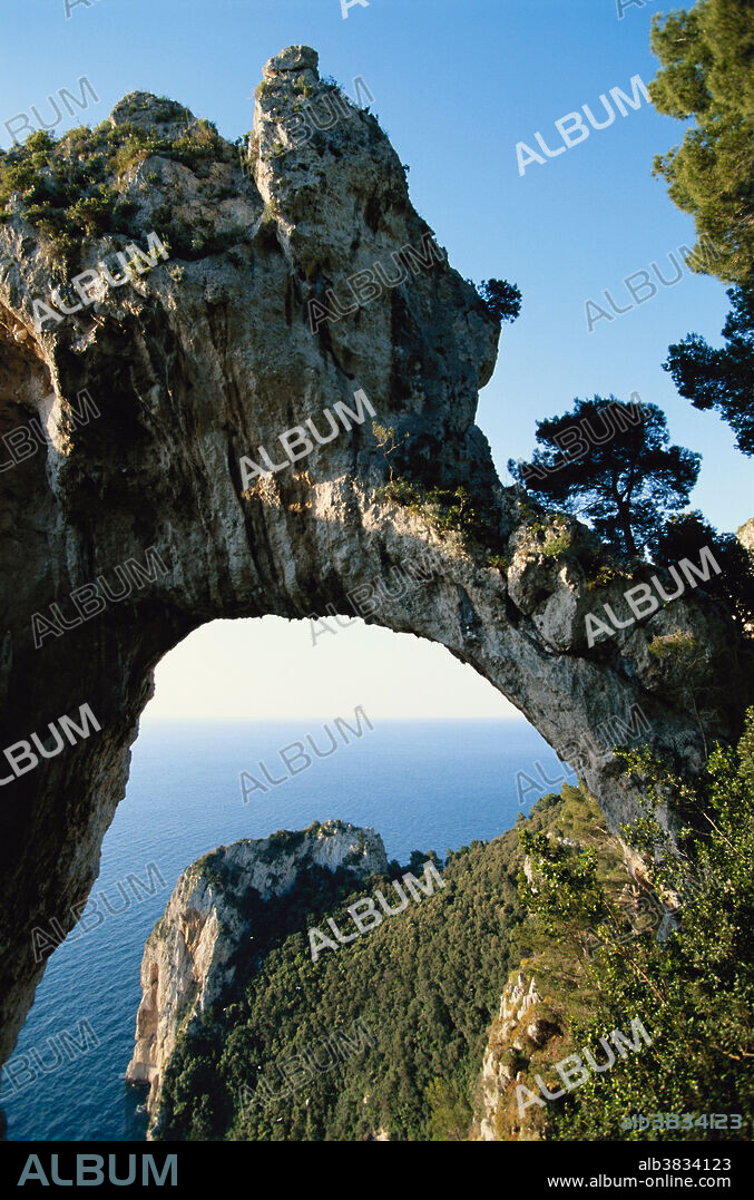 The Arco Naturale, a dramatic natural limestone arch on the east coast of the island of Capri, Italy. Dating from the Paleolithic age, it is the remains of a collapsed grotto.